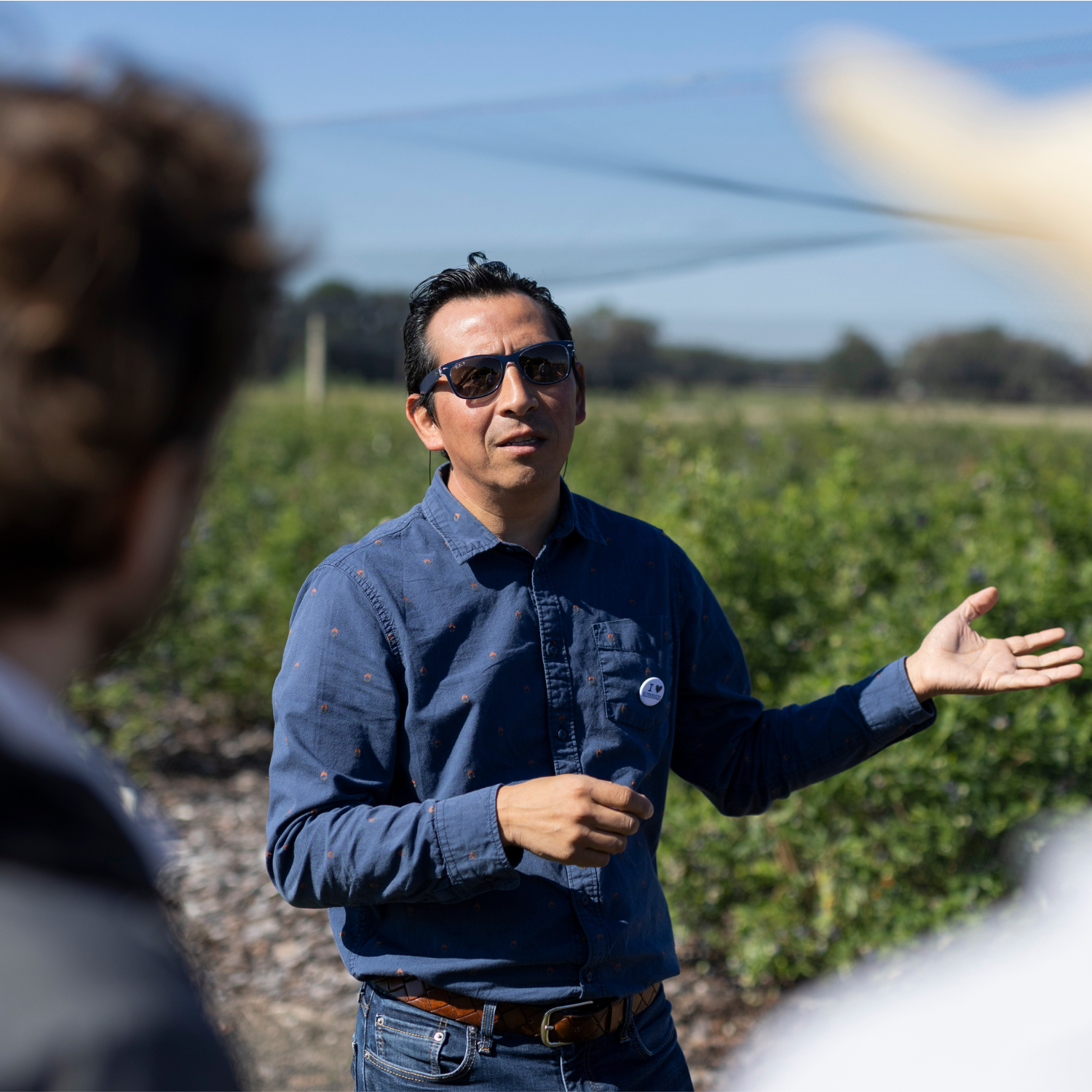 Dr. Munoz in the field giving tour to people