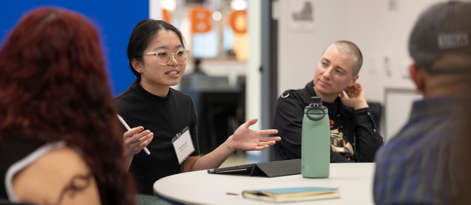 student sitting around round table