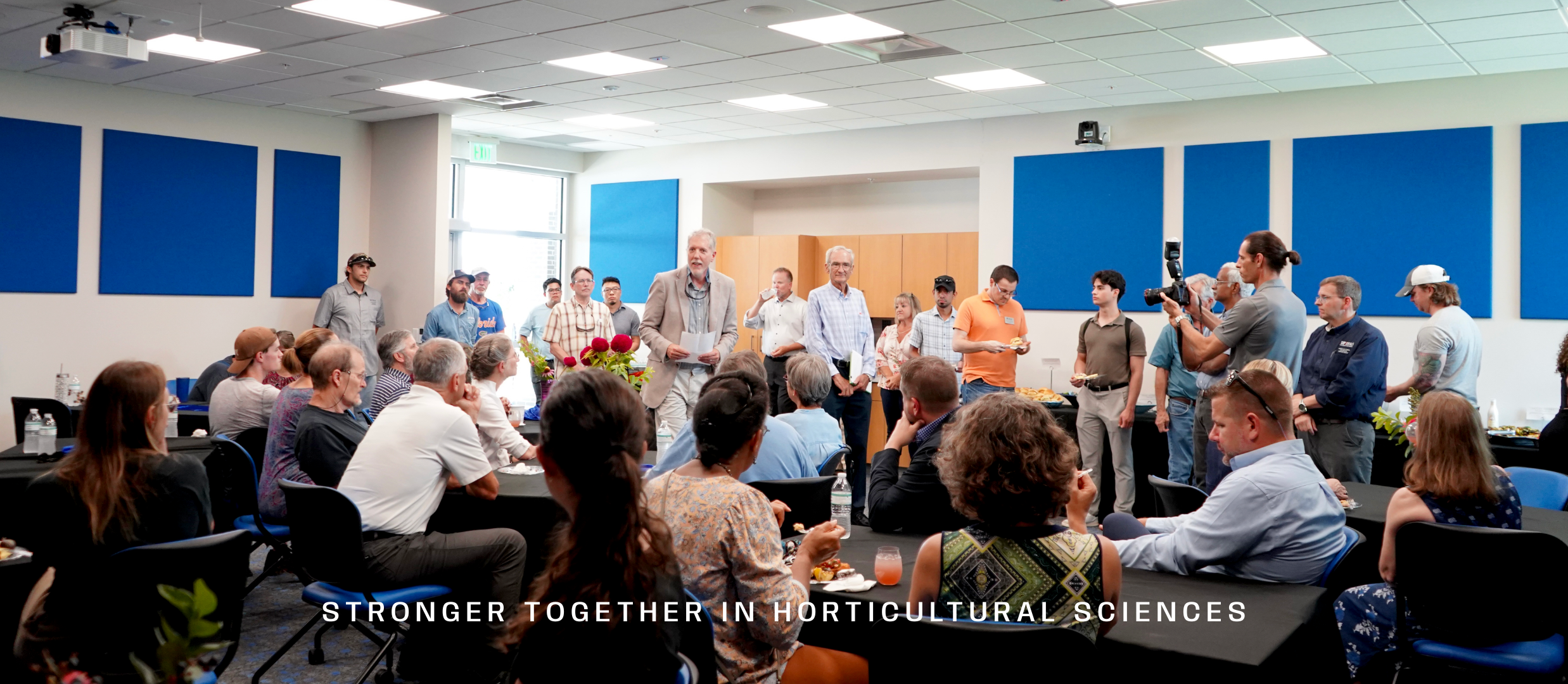 Faculty members meeting in conference room